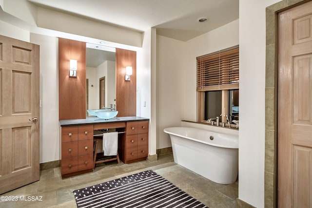 bathroom with vanity and a tub to relax in