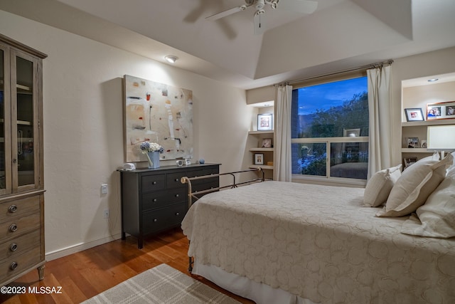 bedroom with ceiling fan, lofted ceiling, and dark hardwood / wood-style flooring