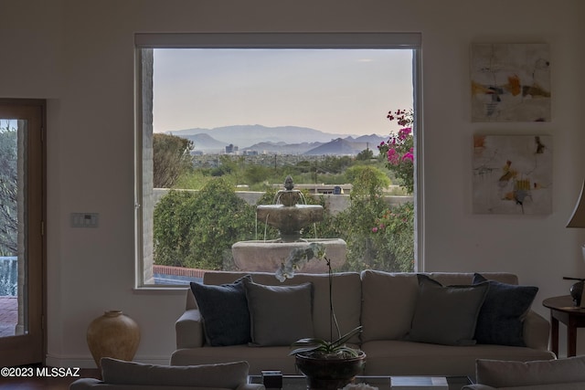 living room featuring a mountain view and a wealth of natural light