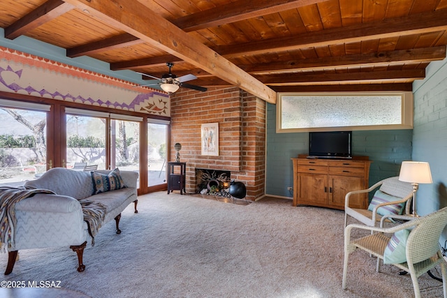 living room featuring beamed ceiling, a brick fireplace, light carpet, and wooden ceiling