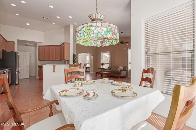 tiled dining area with ceiling fan