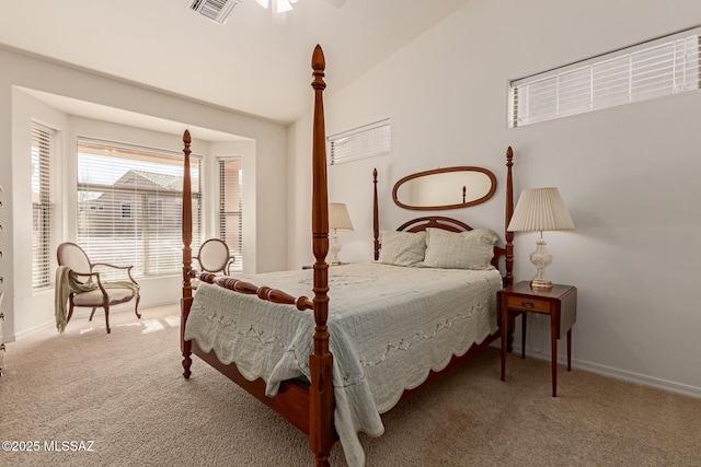 carpeted bedroom with ceiling fan and vaulted ceiling