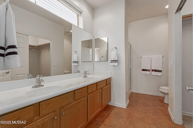 bathroom with an enclosed shower, tile patterned floors, vanity, and toilet