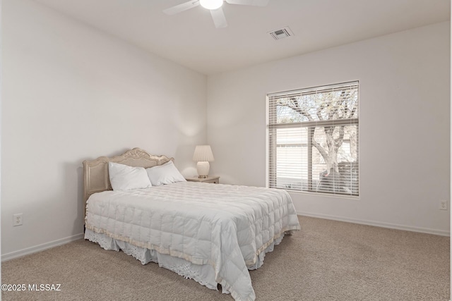 carpeted bedroom featuring ceiling fan and multiple windows