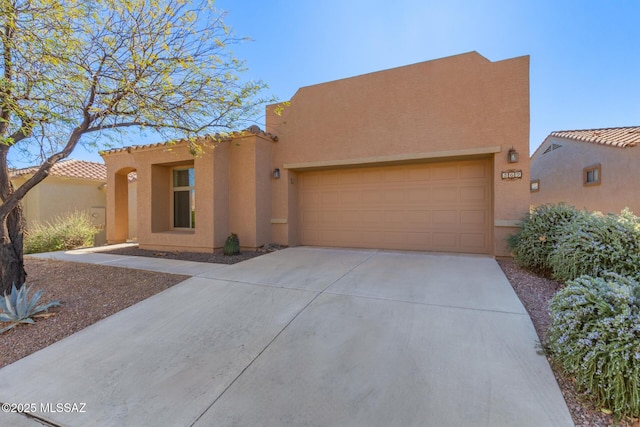 pueblo-style home featuring a garage