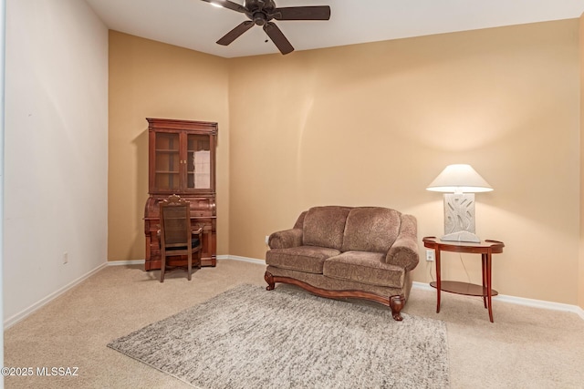 sitting room with ceiling fan and carpet flooring