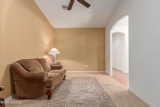 living area featuring ceiling fan and light colored carpet