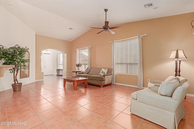 tiled living room featuring ceiling fan and vaulted ceiling