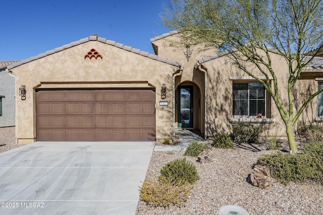 pueblo-style house featuring a garage