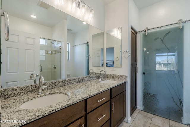 bathroom featuring vanity, toilet, a wealth of natural light, and an enclosed shower