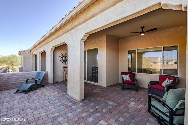 view of patio featuring ceiling fan