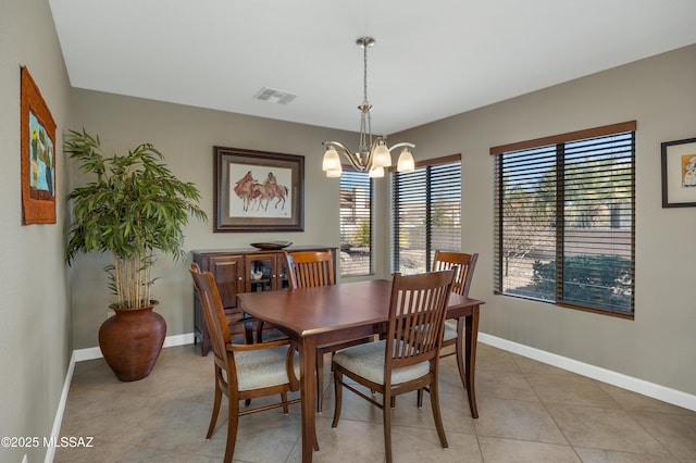 tiled dining area with an inviting chandelier