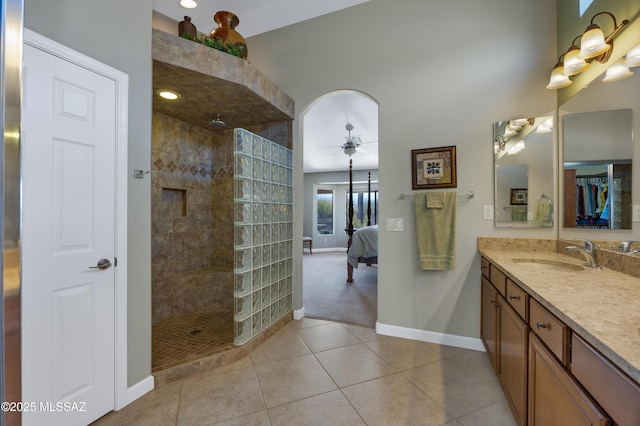 bathroom featuring vanity, tiled shower, tile patterned floors, and ceiling fan