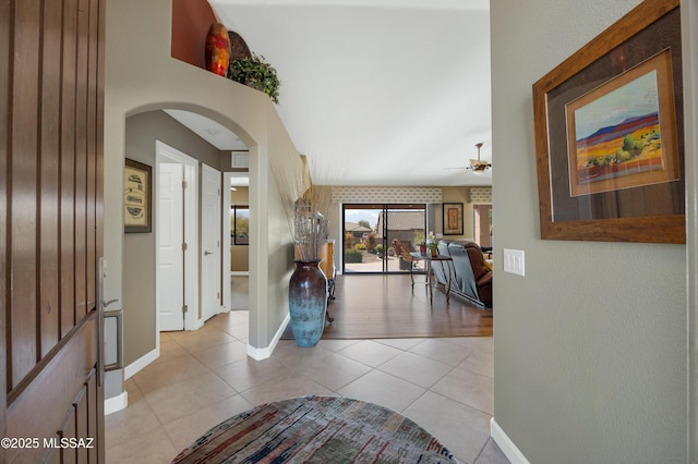 foyer featuring ceiling fan and light tile patterned flooring