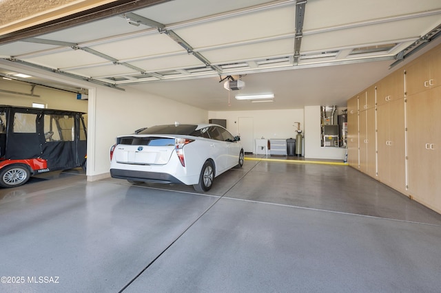 garage with a garage door opener and water heater