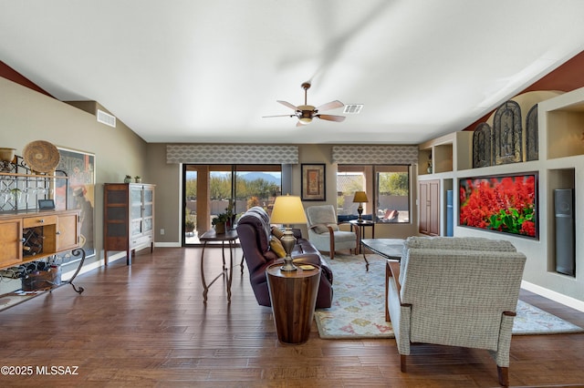 living room featuring ceiling fan, dark hardwood / wood-style flooring, and vaulted ceiling