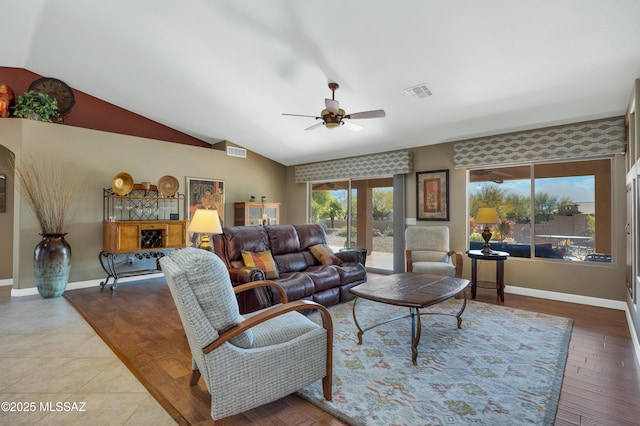 living room featuring ceiling fan, lofted ceiling, and wood-type flooring