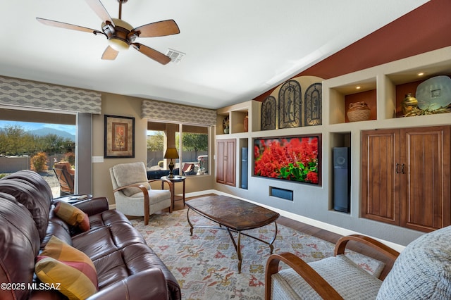 living room with lofted ceiling, wood-type flooring, and ceiling fan