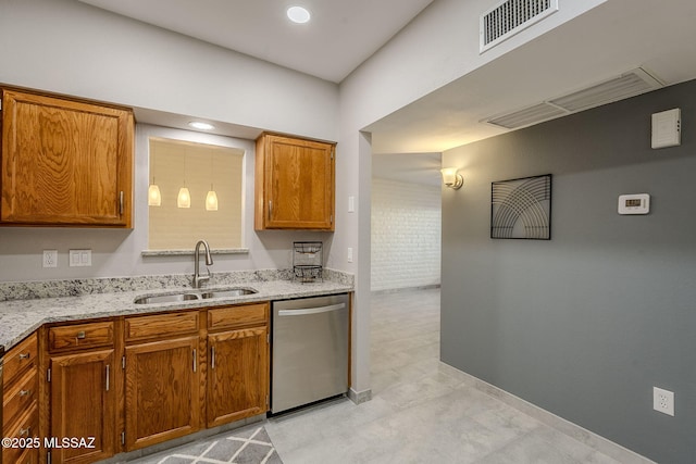 kitchen featuring light stone countertops, sink, and dishwasher