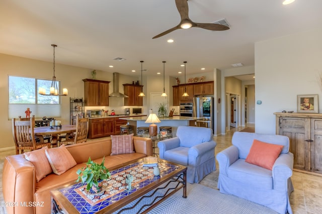 living room featuring ceiling fan with notable chandelier