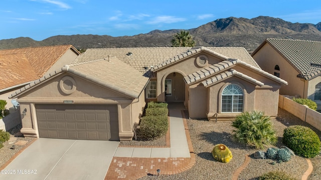 view of front facade with a mountain view and a garage