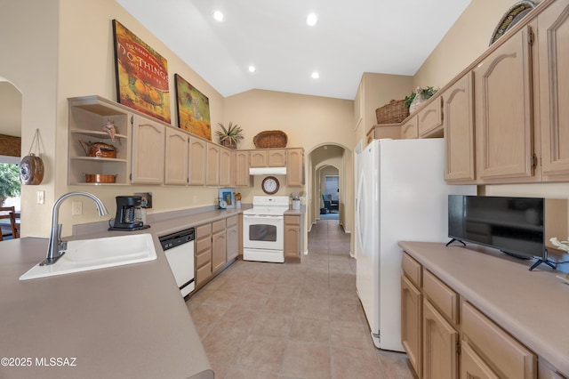 kitchen featuring white appliances, vaulted ceiling, light brown cabinets, sink, and light tile patterned flooring