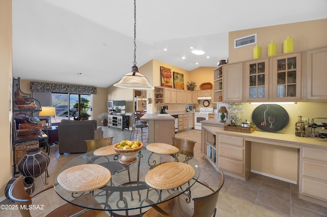 tiled dining space with vaulted ceiling