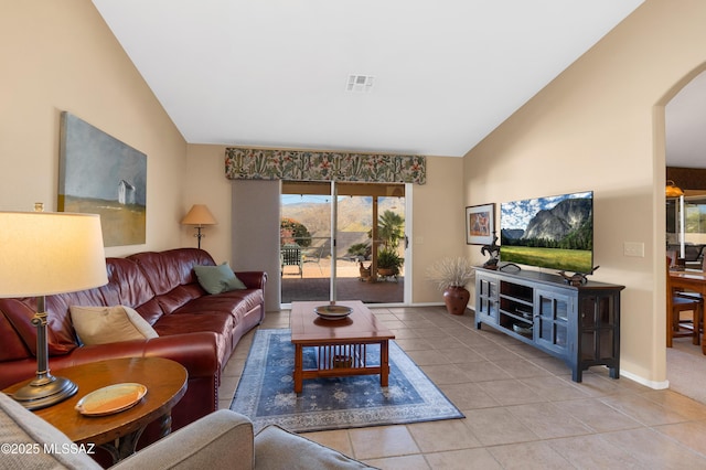 living room featuring light tile patterned floors and vaulted ceiling