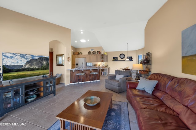 tiled living room with vaulted ceiling