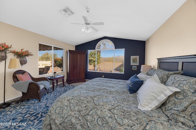 bedroom featuring ceiling fan, lofted ceiling, and multiple windows