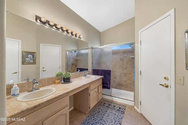 bathroom featuring a shower with shower door, vaulted ceiling, and tile patterned flooring