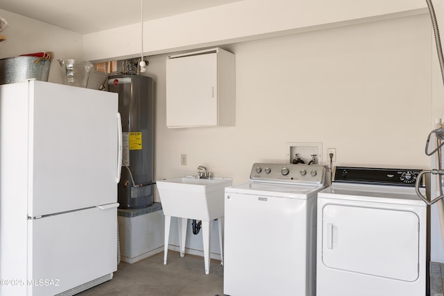 clothes washing area featuring washer and clothes dryer and water heater