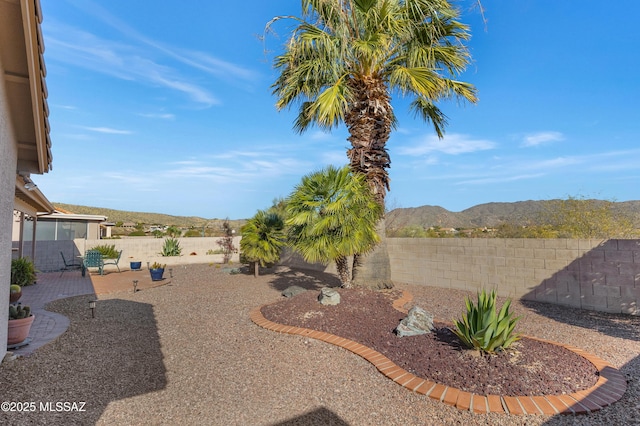 view of yard featuring a mountain view and a patio