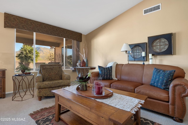 living room with carpet and vaulted ceiling