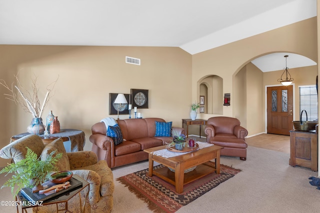 carpeted living room featuring lofted ceiling