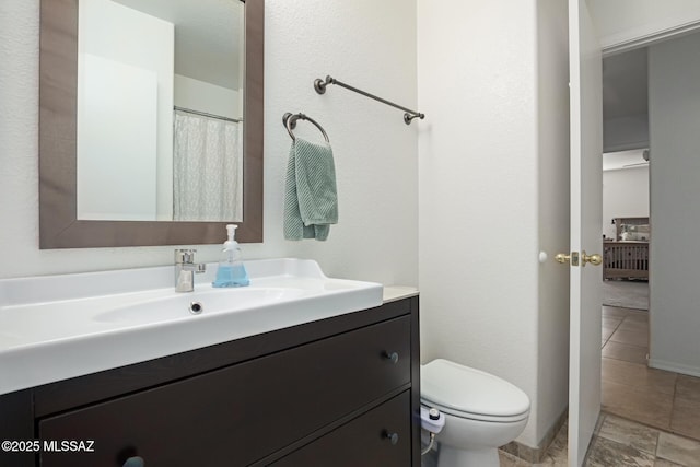 bathroom with toilet and vanity