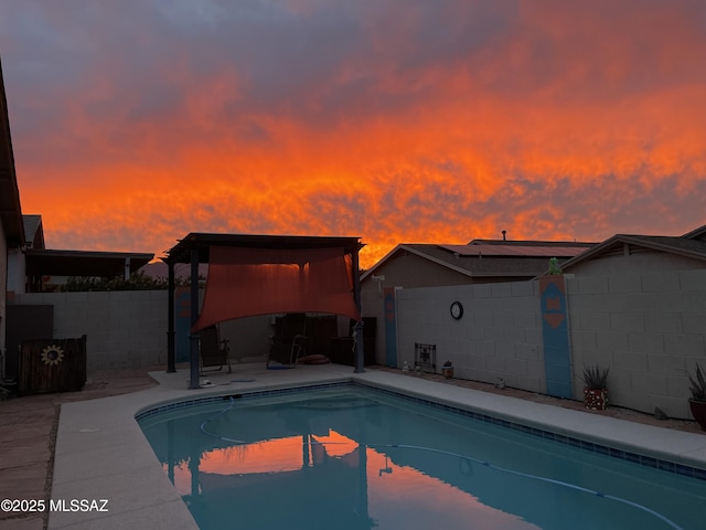 view of pool at dusk