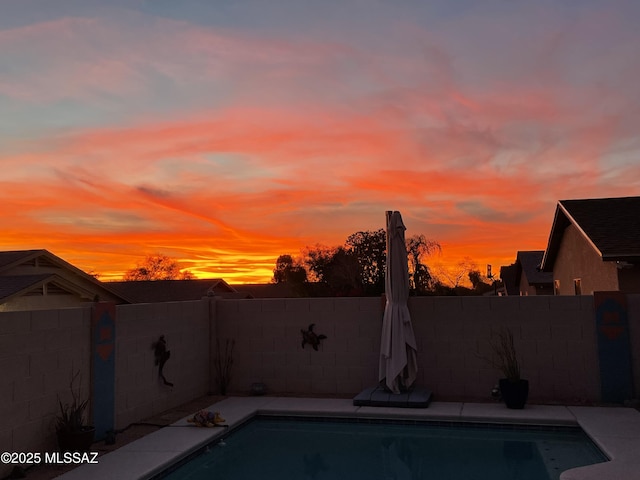 view of pool at dusk