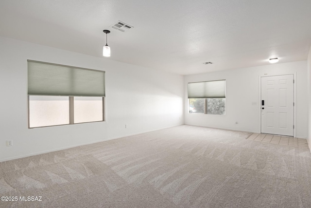 unfurnished room with light colored carpet