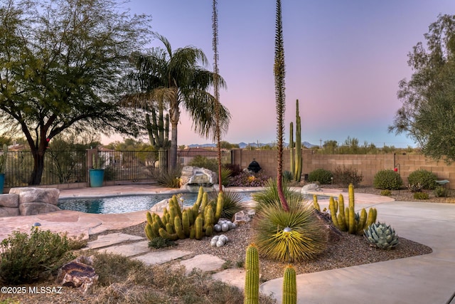 view of pool at dusk