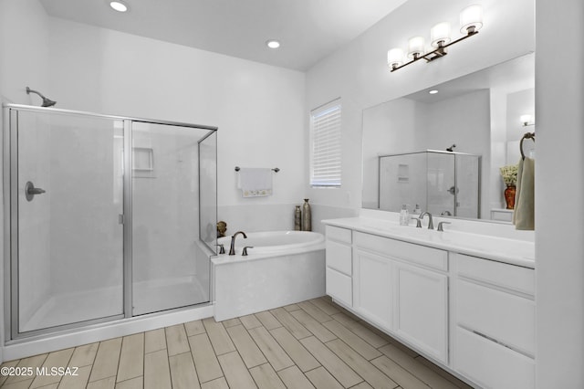 bathroom with separate shower and tub and vanity