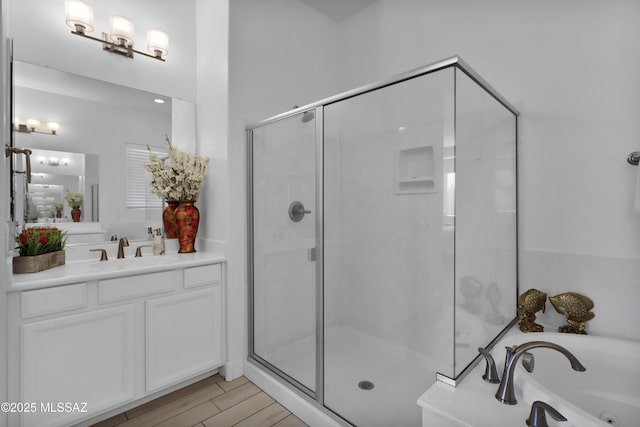 bathroom featuring vanity and plus walk in shower