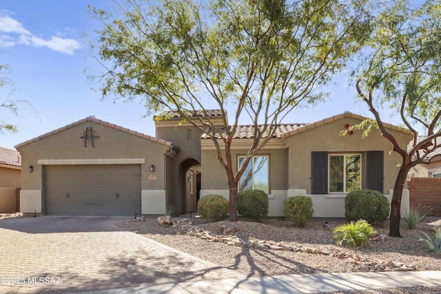 mediterranean / spanish home featuring a garage