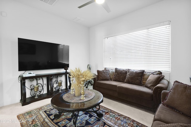 carpeted living room featuring ceiling fan