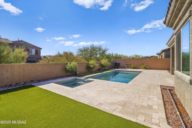 view of swimming pool with an in ground hot tub and a patio