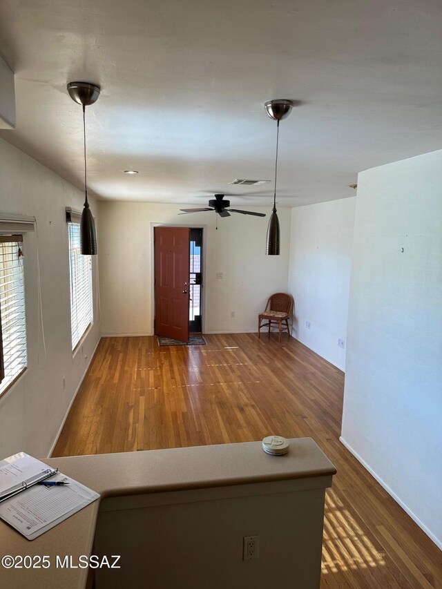 unfurnished living room featuring sink, ceiling fan, and wood-type flooring