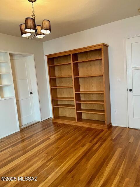 unfurnished living room featuring hardwood / wood-style floors and ceiling fan