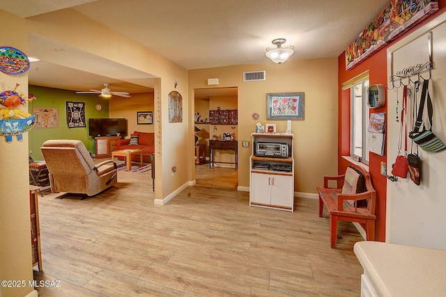 interior space featuring light wood-type flooring and a textured ceiling