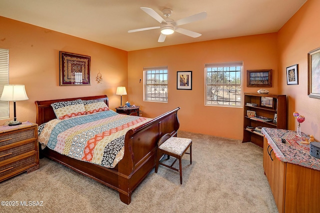 bedroom with ceiling fan and light colored carpet