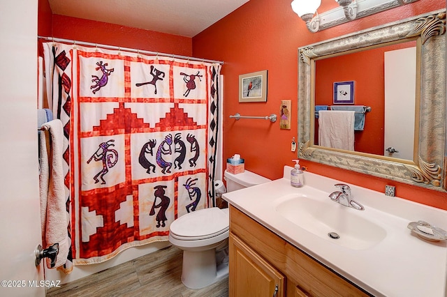 bathroom with toilet, a shower with shower curtain, hardwood / wood-style floors, and vanity